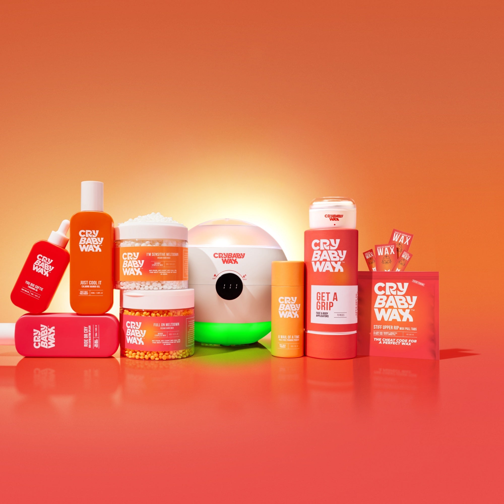 Crybaby Wax product family: vegan hard wax, warmers, prep and aftercare with Stiff Upper Rip pull tabs on a warm sunset gradient